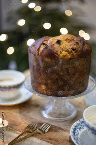 Panettone. Traditional Italian Christmas cake with orange, candied fruit, raisins and cinnamon. Panettone with cappuccino, festive food. 