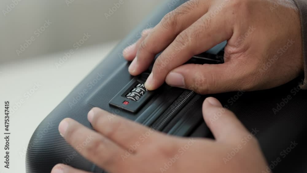 Close up male finger Trying to unlock the luggage by input security codes. Man open suitcase organizer luggage. Close up male finger Trying to unlock the luggage by input security codes. Man open suitcase organizer luggage.