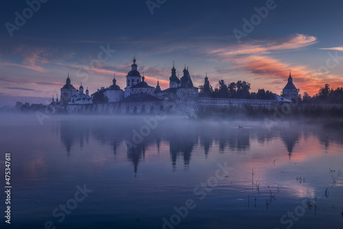 Attractive and unique view of the Kirillo-Belozersky Orthodox monastery. Misty and quiet morning on the lake. Country landscape. Dawn. Russian northern style. Vologda. Kirillov. Russia.