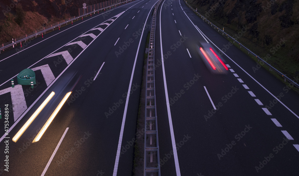 Car lights at dusk on the A8 highway, Euskadi