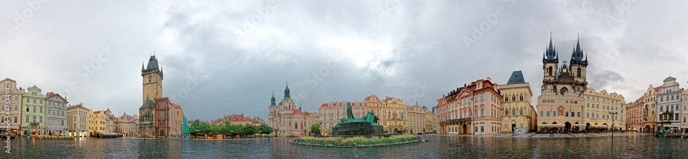 Fototapeta premium Panorama view of Old Town Square in Prague, Czech Republic with landmarks of Old Town Hall, Astronomical Clock Tower, Gothic Church of Our Lady before Tyn, Jan Hus Memorial & the St. Nicholas Church