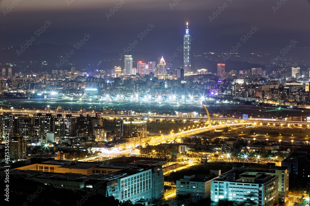 Aerial panorama of busy Taipei City, Keelung River, Dazhi Bridge, Songshan Airport & Taipei 101 in XinYi District at dusk ~ A romantic night in Taipei downtown with beautiful skyline in background 