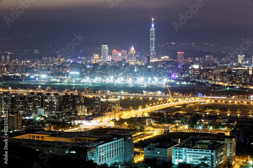 Aerial panorama of busy Taipei City, Keelung River, Dazhi Bridge, Songshan Airport & Taipei 101 in XinYi District at dusk ~ A romantic night in Taipei downtown with beautiful skyline in background 