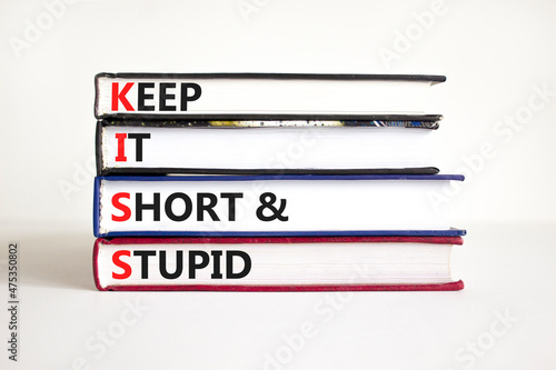 KISS keep it short and stupid symbol. Concept words KISS keep it short and stupid on books. Beautiful white table, white background. Business KISS keep it short and stupid concept. Copy space. photo