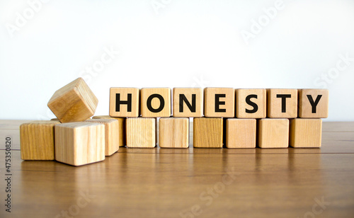 Honesty symbol. The concept word Honesty on wooden cubes. Beautiful wooden table, white background, copy space. Business and honesty concept. photo