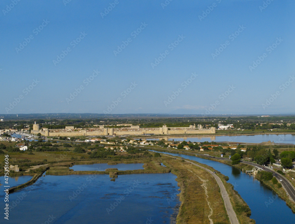 France, Occitanie, Gard, Petite Camargue, the medieval town of Aigues Mortes surrounded by the salt marshes (Salins du Midi) (aerial view)