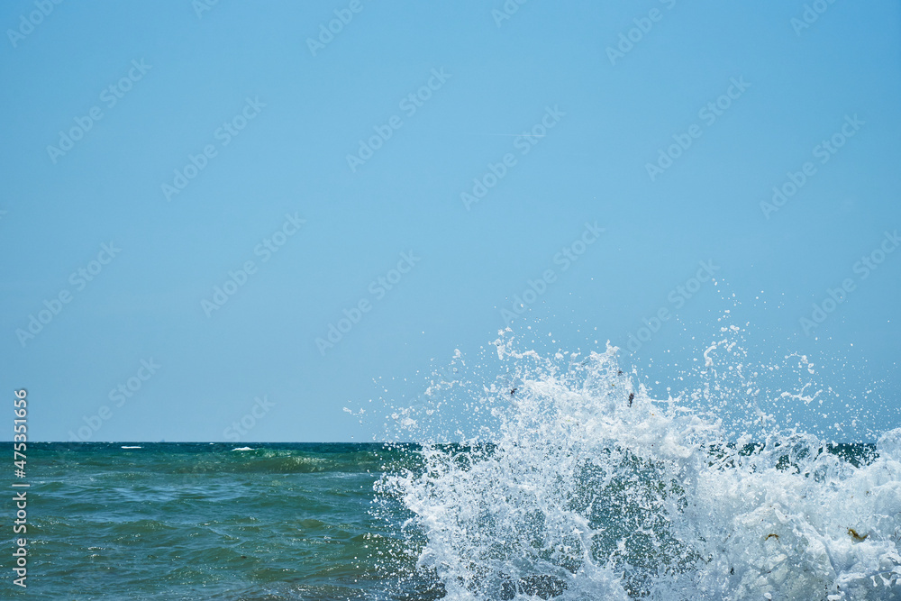 Image of the sea shore. In the background is a warship. Image of the sea shore. In the background is a warship.