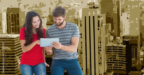 Composite image of caucasian couple holding a digital tablet against against tall buildings painting