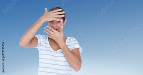 African american woman hiding her face against blue and white gradient background
