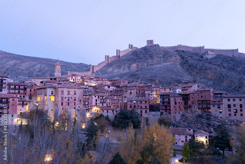 Medieval walls on the hill and the beautiful tourist village of Albarracín in autumn. Architecture and historical heritage in Teruel, Spain. Travel, Nature, Landscape, Vacation concept.