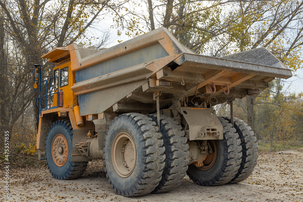 Large mining dump truck. Transport industry. Extraction of stone in an open pit Large mining dump truck. Transport industry. Extraction of stone in an open pit