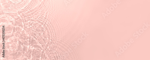 Fresh water background. Light pink pattern with natural rippled water texture. Web banner with copy space. Cosmetic water surface background.