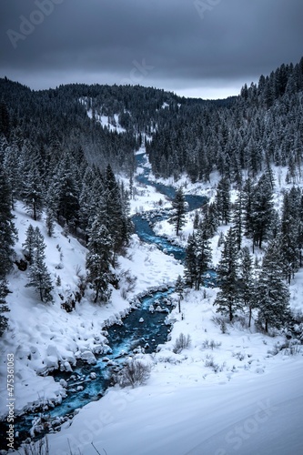 Snow-covered mountains with a blue river winding through.
