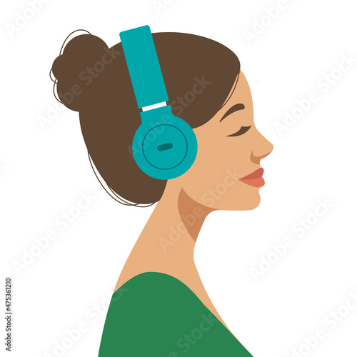 young brunette woman wearing headphones and listening to music or podcast
