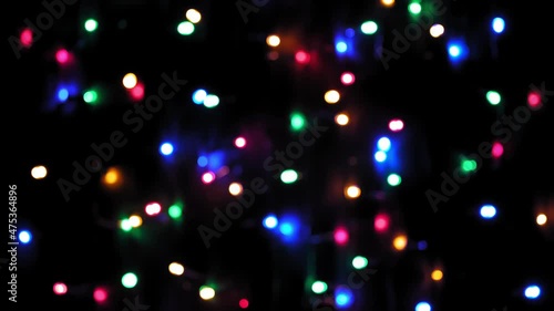 4k. Christmas mood, round defocused multicolored lights. Beautiful New Year screensaver. Merry christmas congratulation. Abstract background of glowing garlands at night. Christmas Garland