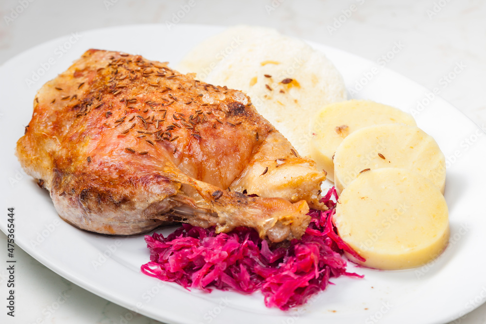 roasted goose leg with red cabbage and dumplings