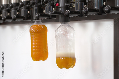 New modern beer taps with plastic bottles on bar counter in pub photo