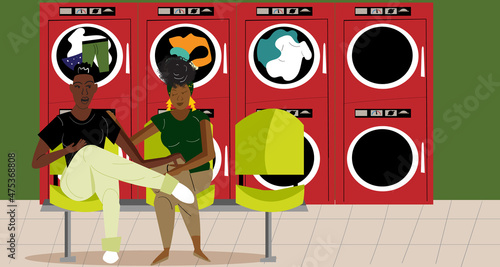 Lesbian couple in the laundromat talking while the clothes are drying 