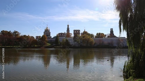 View of the Novodevichy convent (Bogoroditse-Smolensky monastery) and the big Novodevichy pond on a sunny autumn day. Moscow, Russia. UNESCO world heritage site photo