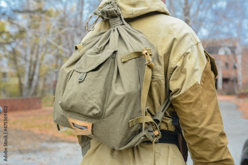 A man in a protective overalls with a bag. Uniform for a stalker. Old Soviet military bag. A man in a protective overalls with a bag. Uniform for a stalker. Old Soviet military bag.