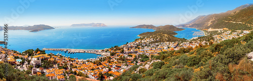 Charming panoramic aerial view of seaside resort town of Kas in Turkey. Harbor with port and white houses with orange roofs waiting for tourists. Turkish riviera and vacation