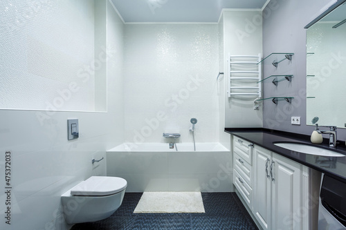 Fancy high gloss bathroom with basin cabinet, mirror, toilet, washer