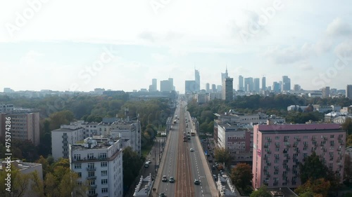 Morning low traffic on long straight and wide Jerusalem Avenue, Aleje Jerozolimskie. Skyline with modern high rise office buildings. Warsaw, Poland photo