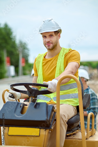 Man driving special vehicle looking at camera