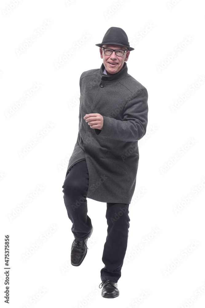 cheerful man in a hat and autumn coat striding forward . cheerful man in a hat and autumn coat striding forward .