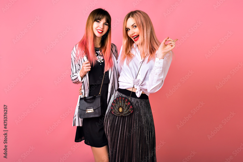 Positive indoor studio portrait of two stylish elegant pretty women having fun on party, Positive indoor studio portrait of two stylish elegant pretty women having fun on party,