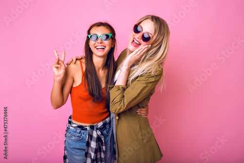 Lifestyle cheerful portrait or two stylish pretty woman posing together, ©  AnnaHar