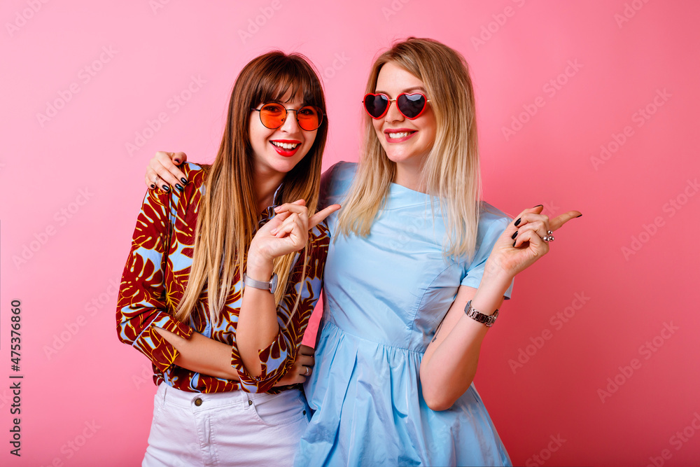 Two happy pretty sisters best friends hipster women having fun together Two happy pretty sisters best friends hipster women having fun together