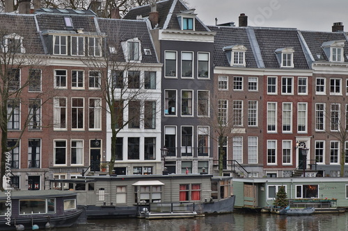 Amsterdam Canal View with Traditional Architecture and Houseboats  Netherlands
