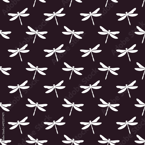 Dark purple seamless pattern with white dragonflies. Cute and childish design for fabric  textile  wallpaper  bedding  swaddles toys or gender-neutral apparel.