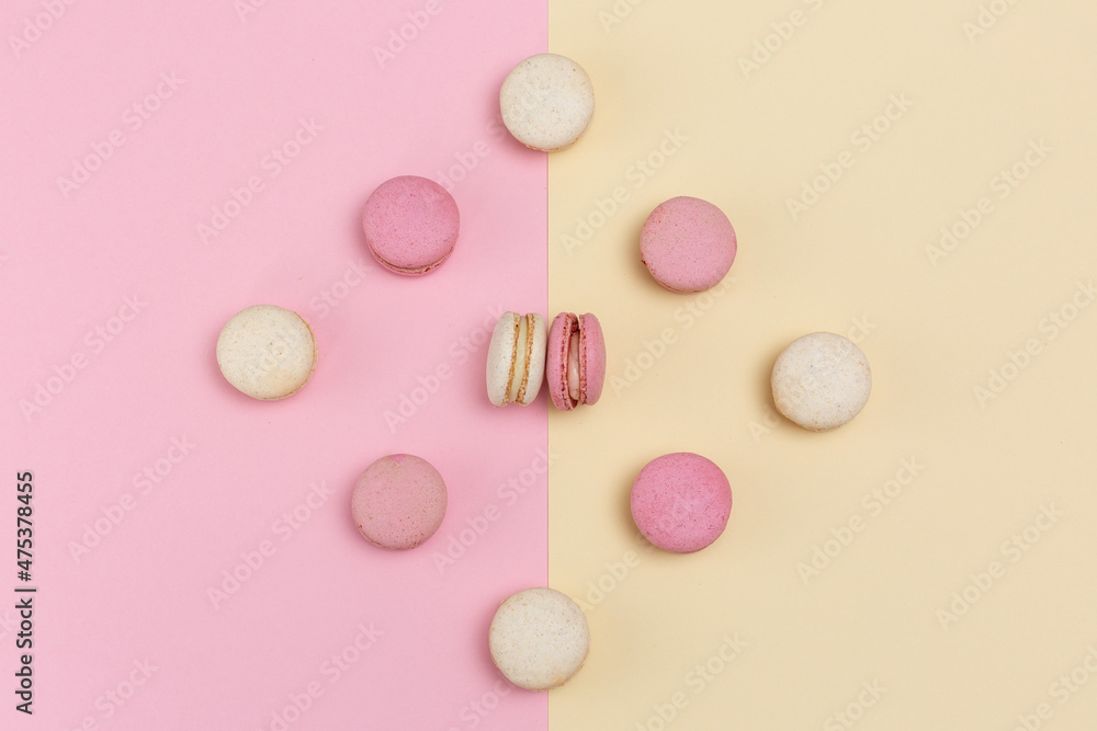macarons cakes with vanilla and berry flavor on a background of pastel shades macarons cakes with vanilla and berry flavor on a background of pastel shades