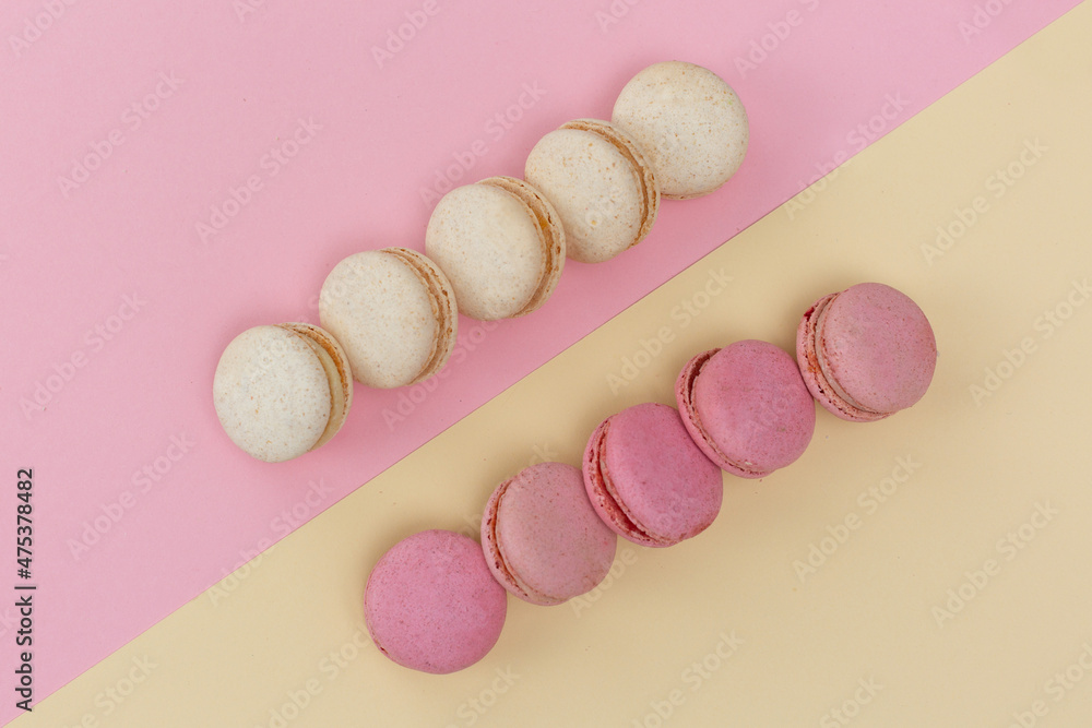 macarons cakes with vanilla and berry flavor on a background of pastel shades macarons cakes with vanilla and berry flavor on a background of pastel shades