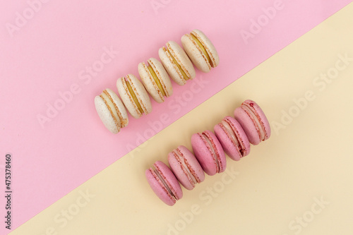 macarons cakes with vanilla and berry flavor on a background of pastel shades