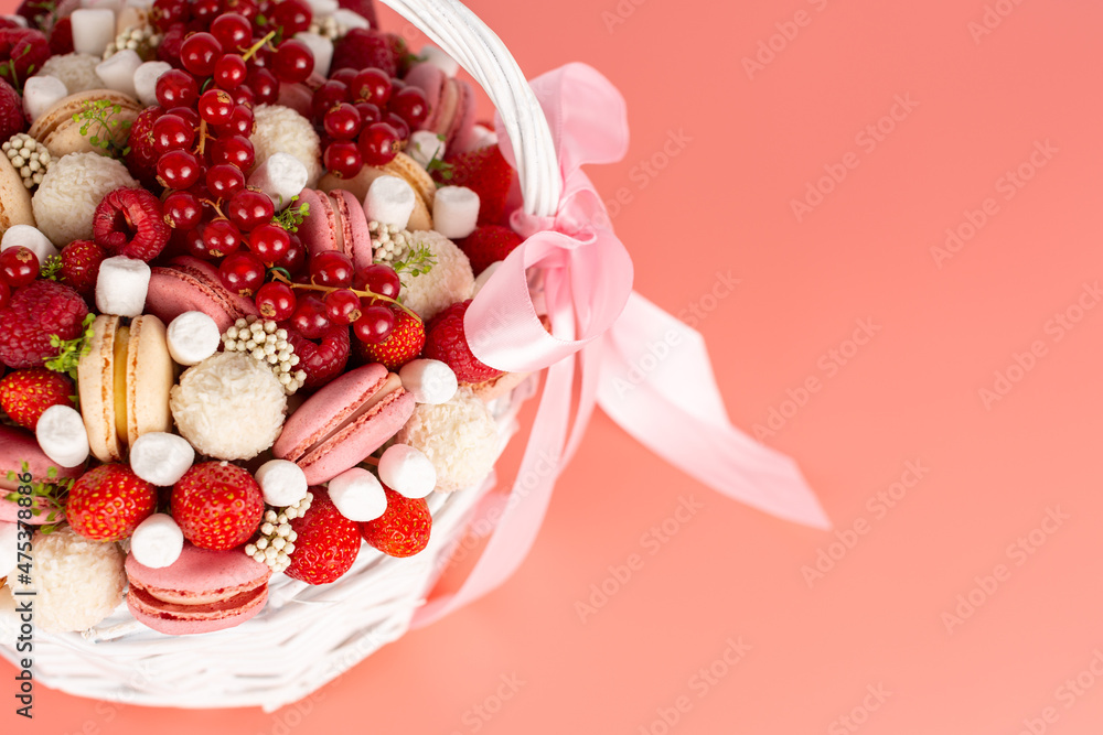 White wicker basket with berries and sweets
