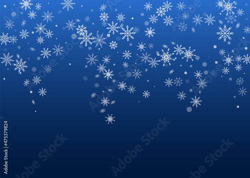White delicate openwork snowflakes are scattered on a blue background. Festive background, postcard design, wallpaper