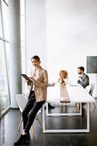 Young woman holding digital...