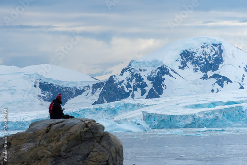 Tourist watching Northeast Glacier on Stonington Island, Antarctica photo