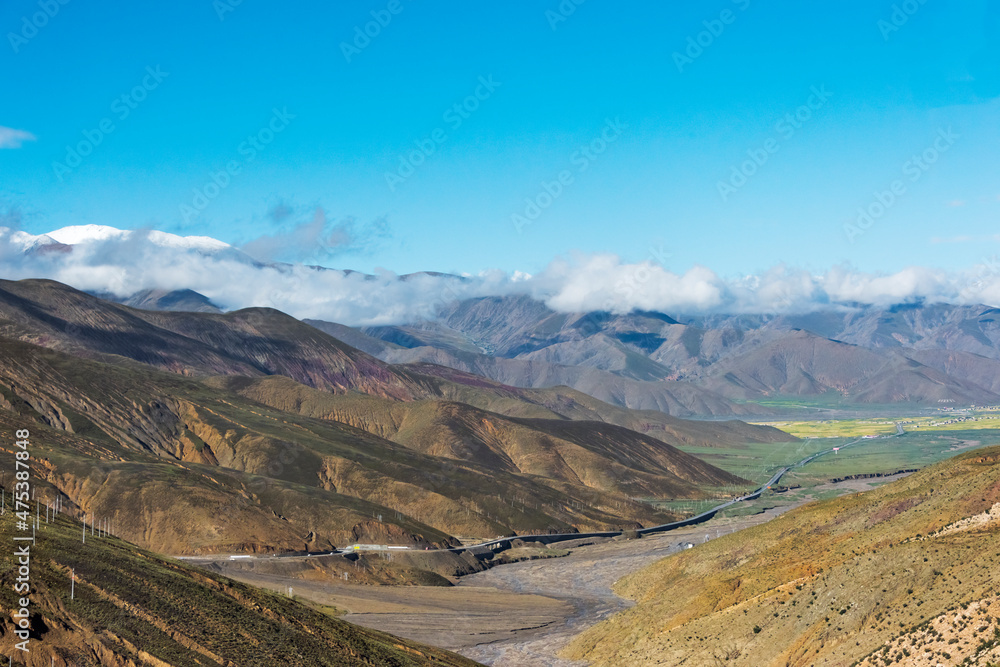Road in the Himalayas, cell signal receiving poles on the mountain slope, Shigatse Prefecture, Tibet, China Road in the Himalayas, cell signal receiving poles on the mountain slope, Shigatse Prefecture, Tibet, China