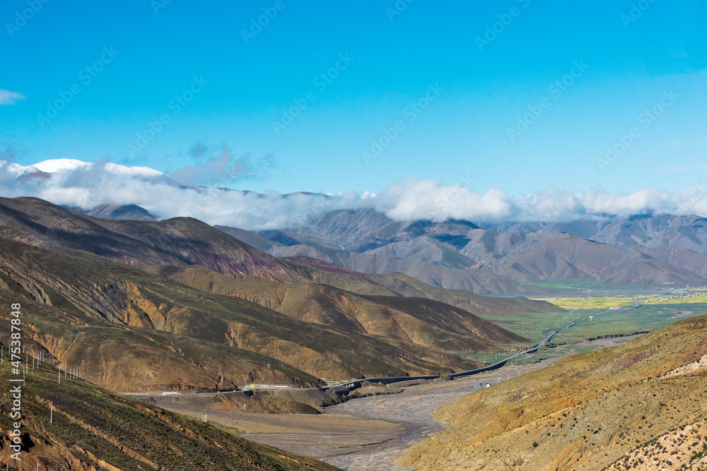 Road in the Himalayas, cell signal receiving poles on the mountain slope, Shigatse Prefecture, Tibet, China