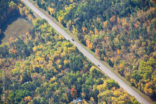 Aerial view of highway in northern Minnesota on a sunny autumn day