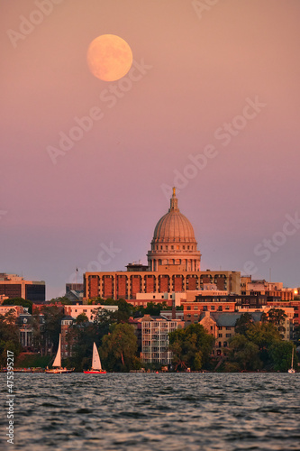 Full moon rising over the Wisconsin State Capitol and Madison, WI skyline on the shore of Lake Mendota. 