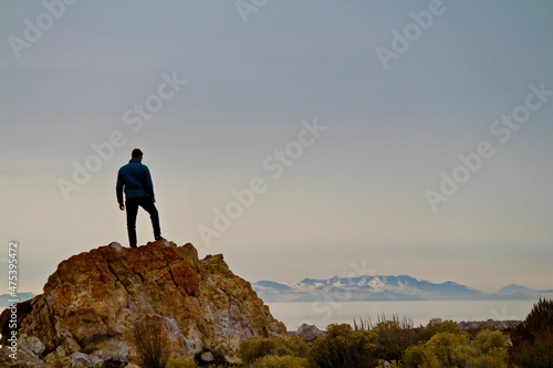 silhouette of a man on the top of the mountain