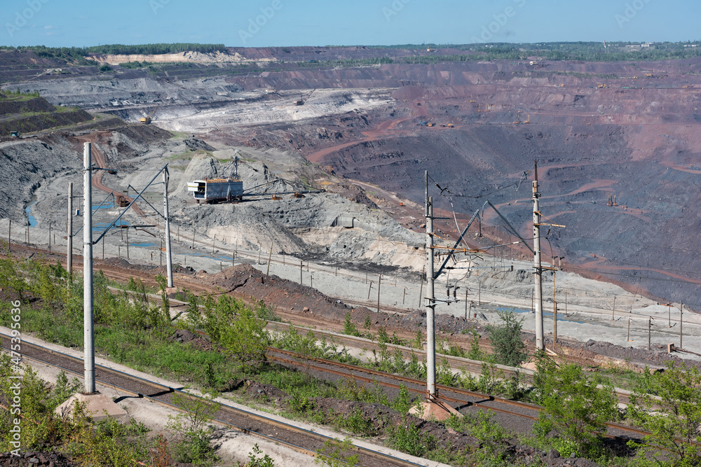 Open iron ore quarry with walking excavator, railway transportation Open iron ore quarry with walking excavator, railway transportation