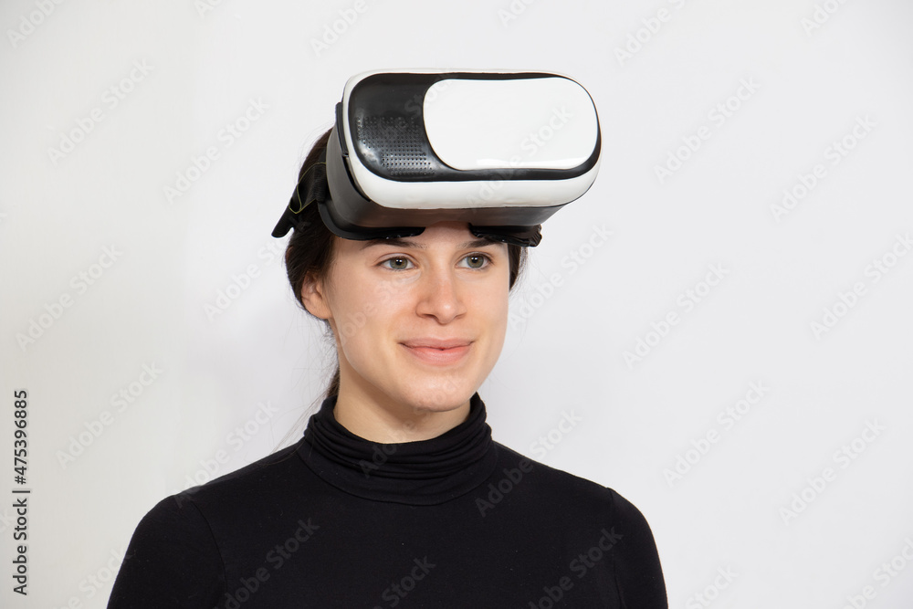 Woman wearing VR glasses on forehead isolated in white background Woman wearing VR glasses on forehead isolated in white background