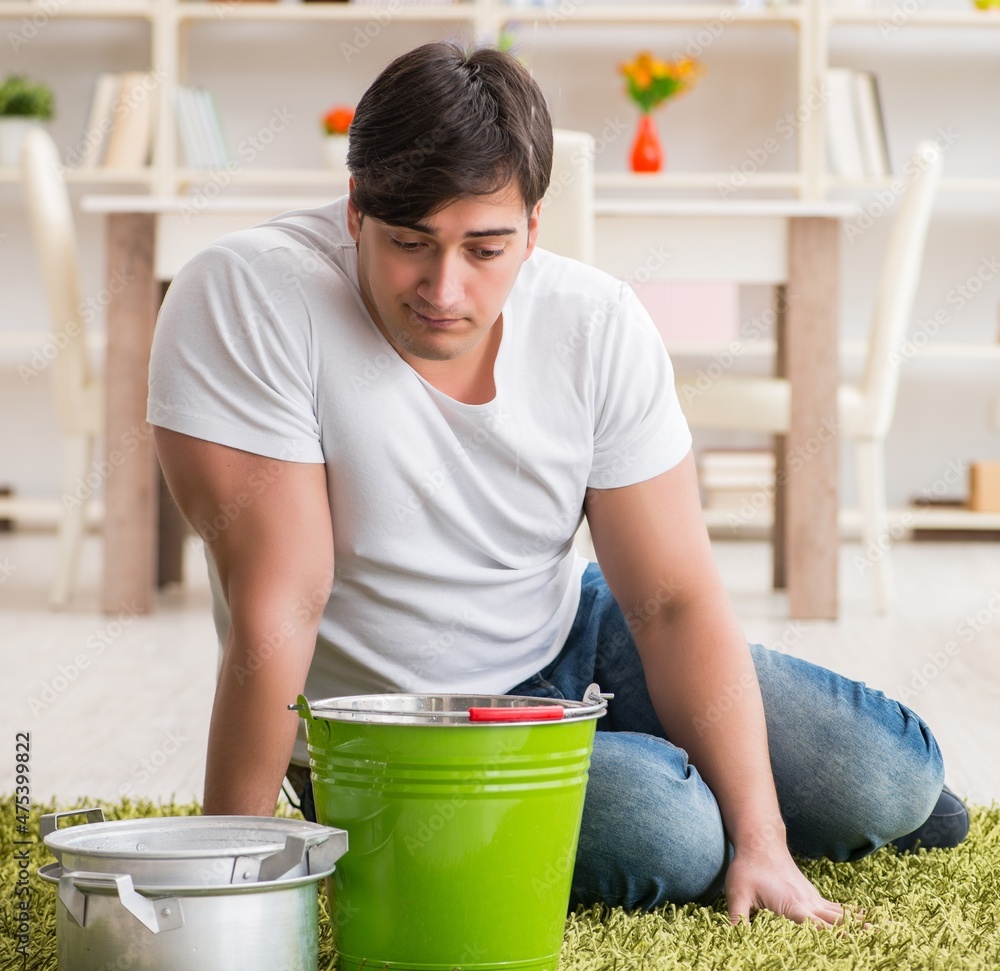 Man at home dealing with neighbor flood leak Man at home dealing with neighbor flood leak