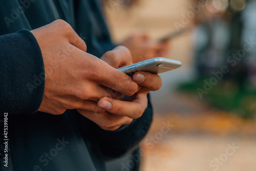 close-up of young people's hands with mobile phones